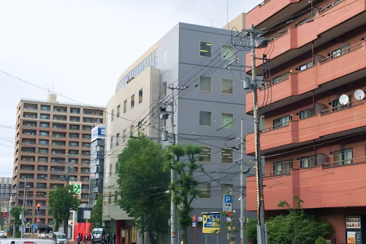 交差点沿いに立ち並ぶマンションやオフィスビルを写した街並みの写真